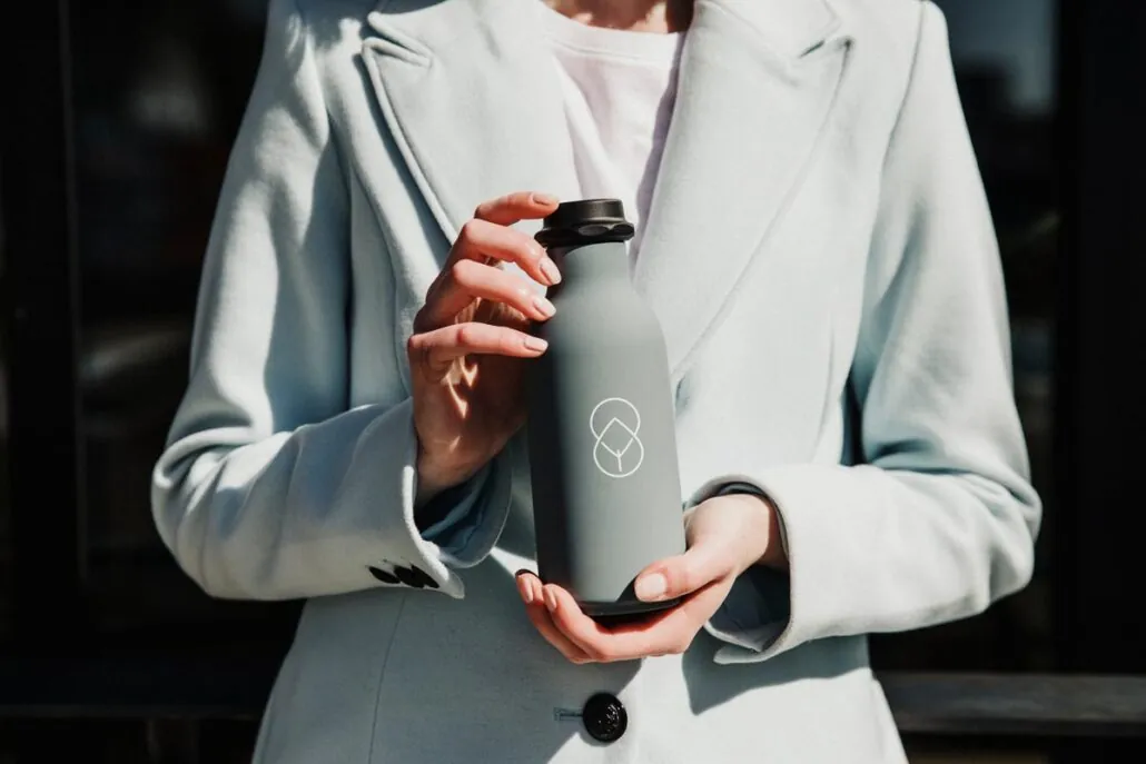 A person holding a branded tumbler